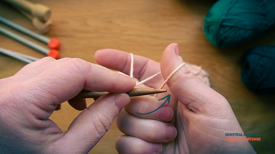 p) insert needle under yarn on thumb